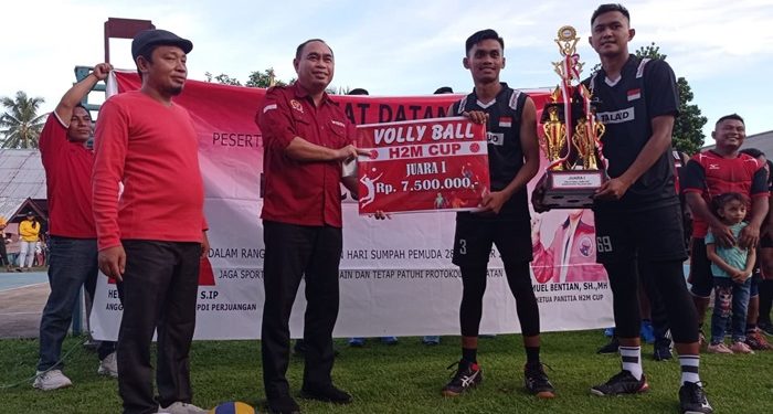 Tenaga ahli anggota DPR-RI Hj. Herson Mayulu, S.IP, Widdy Mokoginta, S.IP saat memberikan hadiah kepada pemenang Volly Ball H2M Cup.