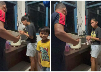 Foto: Aksi Elysia Kaghoo saat membawa Rice Coocer ke pos jaga PLN Tahuna. (Dok. Istimewa)