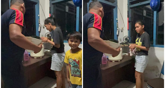 Foto: Aksi Elysia Kaghoo saat membawa Rice Coocer ke pos jaga PLN Tahuna. (Dok. Istimewa)