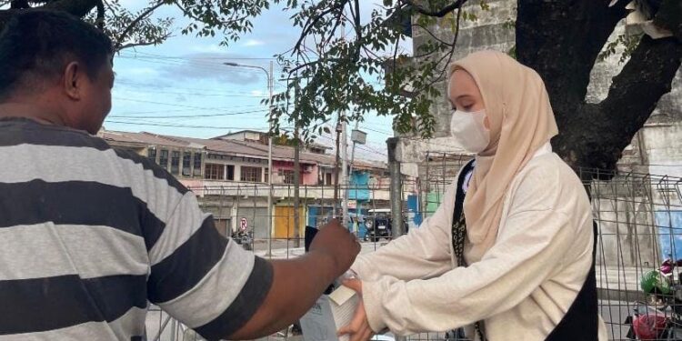 Duta Potensi Pemuda Indonesia Perwakilan Sulut saat membagikan masker gratis kepada masyarakat. (Foto: istimewa).