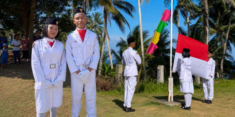 Foto: Arjun Makatiho dan Ethel Mae Mendome saat bertugas sebagai pengibar bendera di perbatasan Indonesia-Filipina di Kampung Matutuang Kepulauan Marore. (Dok. Rendy/Barta1)